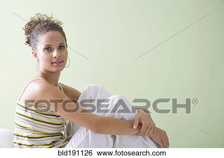 Stock Photograph - Mixed race woman relaxing. Fotosearch
