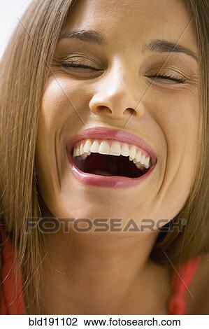Stock Image - Mixed race woman smiling with eyes closed. Fotosearch