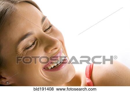 Stock Photo - Mixed race woman smiling with eyes closed. Fotosearch