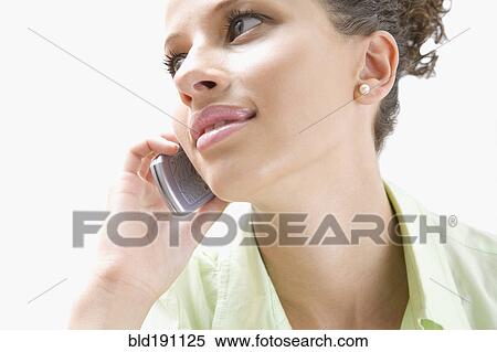 Stock Photography - Mixed race woman talking on cell phone. Fotosearch
