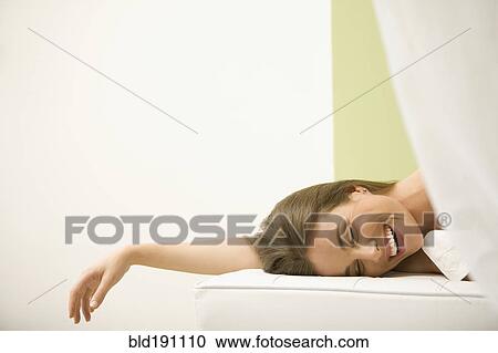 Stock Image - Mixed race woman waiting for spa treatment. Fotosearch