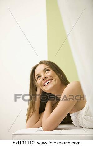 Stock Image - Mixed race woman waiting for spa treatment. Fotosearch