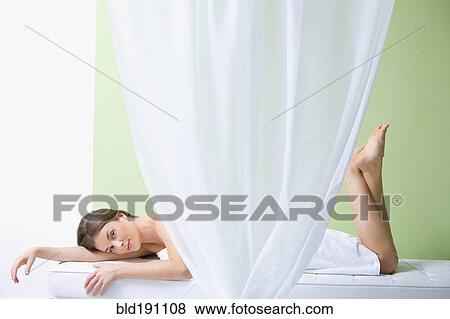 Stock Photo - Mixed race woman waiting for spa treatment. Fotosearch