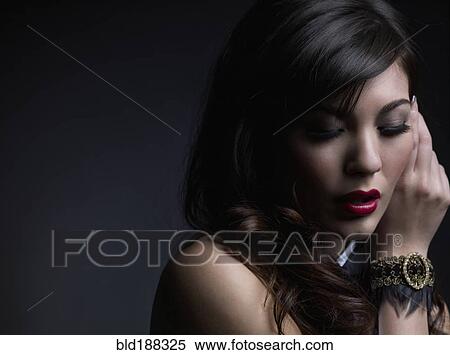 Stock Photography - Mixed Race woman wearing bracelet. Fotosearch