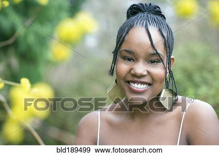 Mixed race woman wearing earrings smiling View Large Photo Image Stock Photo - Mixed race woman wearing earrings smiling. Fotosearch