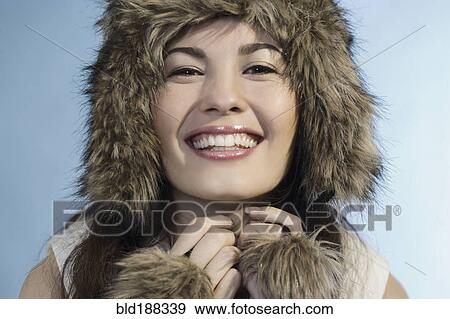 Stock Photo - Mixed Race woman wearing fur hat. Fotosearch