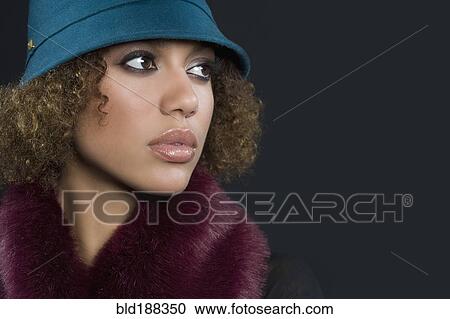 Stock Image - Mixed Race woman wearing hat. Fotosearch