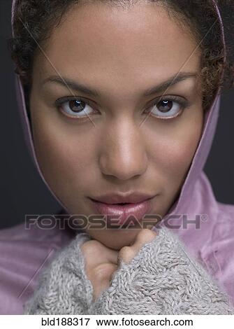 Stock Photo - Mixed Race woman wearing hooded shirt. Fotosearch