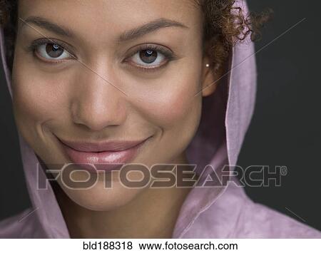 Stock Photo - Mixed Race woman wearing hooded shirt. Fotosearch