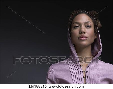 Stock Photography - Mixed Race woman wearing hooded shirt. Fotosearch