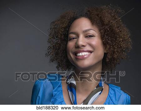 Stock Image - Mixed Race woman wearing scarf around neck. Fotosearch