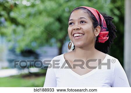 Stock Image - Mixed race woman wearing traditional headscarf. Fotosearch