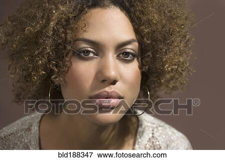 Stock Photo - Mixed Race woman with curly hair. Fotosearch