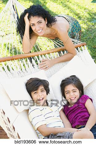 Mother and children relaxing in hammock View Large Photo Image Stock Photograph - Mother and children relaxing in hammock. Fotosearch