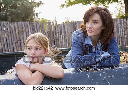 Mother and daughter sitting in truck bed View Large Photo Image Stock Image - Mother and daughter sitting in truck bed. Fotosearch