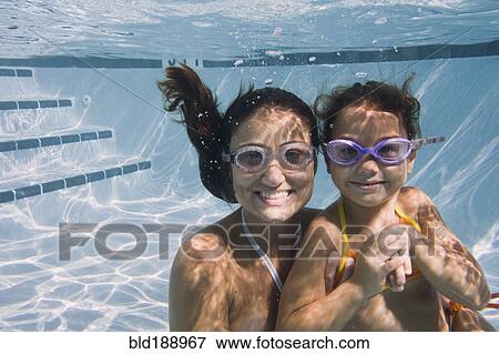 Mother and daughter swimming in swimming pool View Large Photo Image Stock Photo - Mother and daughter swimming in swimming pool. Fotosearch