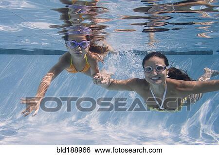 Mother and daughter swimming in swimming pool View Large Photo Image Stock Photograph - Mother and daughter swimming in swimming pool. Fotosearch