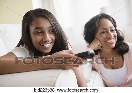 Stock Photo - Mother and daughter watching television. Fotosearch