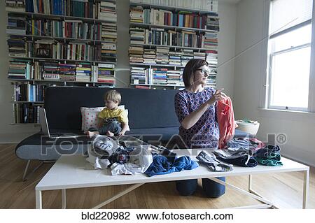 Mother and son folding laundry View Large Photo Image Stock Image - Mother and son folding laundry. Fotosearch