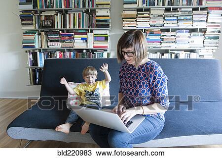 Mother and son using laptop View Large Photo Image Stock Image - Mother and son using laptop. Fotosearch