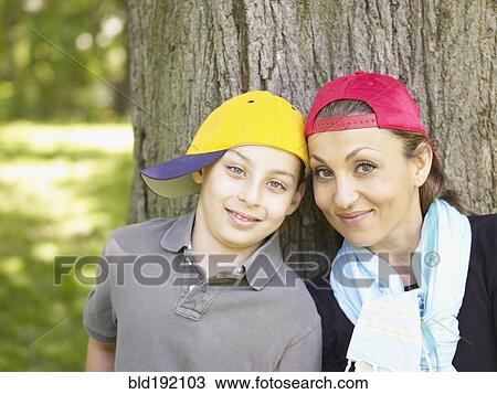Mother and son wearing baseball caps View Large Photo Image Stock Image - Mother and son wearing baseball caps. Fotosearch