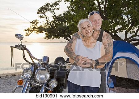 Mother and tattooed son camping at the beach View Large Photo Image Stock Image - Mother and tattooed son camping at the beach. Fotosearch