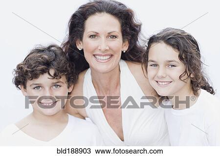 Stock Image - Mother posing with son and daughter for portrait. Fotosearch