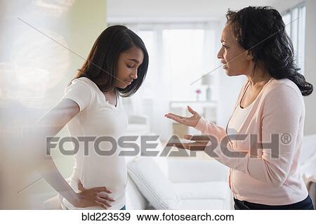 Stock Photo - Mother scolding frustrated daughter . Fotosearch