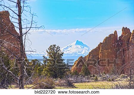 Stock Image - "Mountain behind rock formations, Bend, Oregon, United States, ". Fotosearch