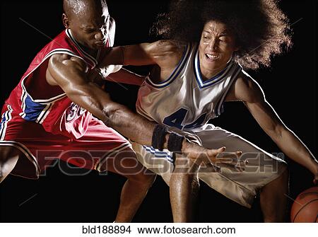 Picture - Multi-ethnic basketball players competing for basketball. Fotosearch