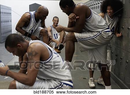 Stock Photography - Multi-ethnic basketball players dressing in locker room. Fotosearch