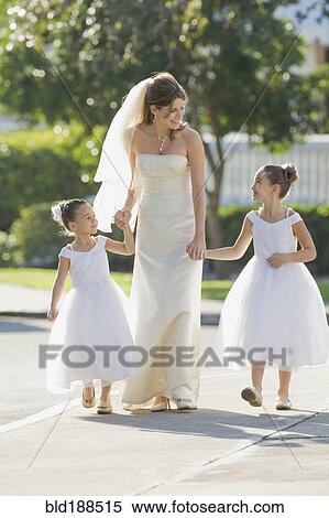 Multi-ethnic bride holding hands with flower girls View Large Photo Image Stock Photography - Multi-ethnic bride holding hands with flower girls. Fotosearch