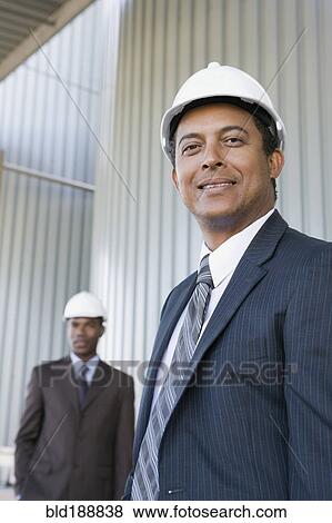 Multi-ethnic businessmen in hard-hats View Large Photo Image Stock Photo - Multi-ethnic businessmen in hard-hats. Fotosearch