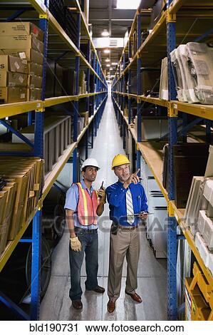Multi-ethnic co-workers in warehouse View Large Photo Image Stock Image - Multi-ethnic co-workers in warehouse. Fotosearch