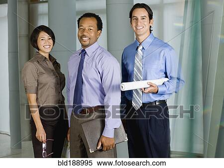 Stock Photography - Multi-ethnic co-workers posing in office. Fotosearch