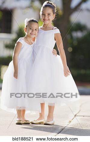 Multi-ethnic flower girls hugging View Large Photo Image Stock Image - Multi-ethnic flower girls hugging. Fotosearch