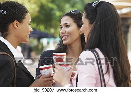 Stock Photo - Multi-ethnic friends having coffee. Fotosearch