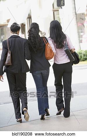 Stock Photo - Multi-ethnic women walking on sidewalk. Fotosearch