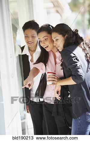 Stock Image - Multi-ethnic women window shopping. Fotosearch