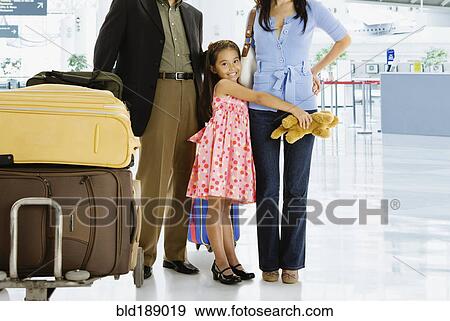 Stock Photo - Multi-generational Asian family posing in airport. Fotosearch