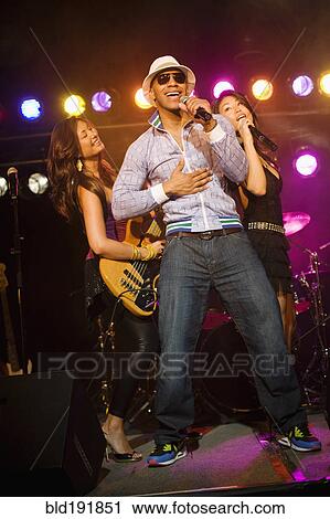 Stock Image - Musical group performing onstage. Fotosearch