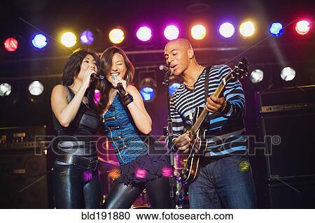 Stock Image - Musical group performing onstage. Fotosearch