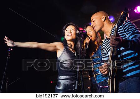 Stock Photo - Musical group performing onstage. Fotosearch