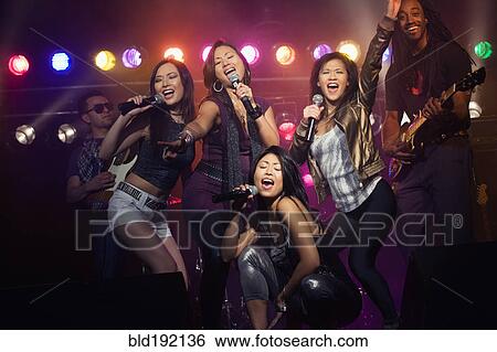 Musical group performing onstage View Large Photo Image Stock Photograph - Musical group performing onstage. Fotosearch