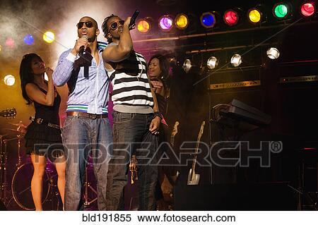 Stock Photography - Musical group performing onstage. Fotosearch