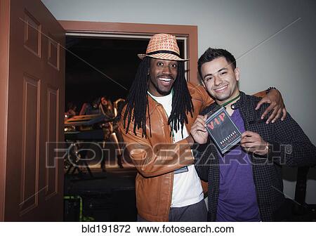 Stock Image - Musician with fan holding VIP pass backstage. Fotosearch
