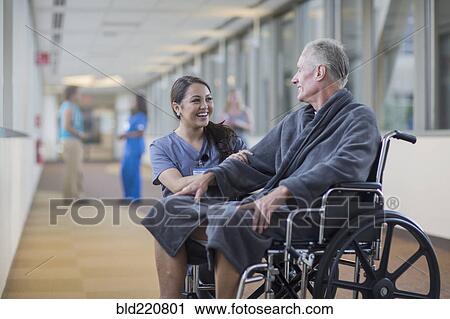 Nurse talking to patient in wheelchair View Large Photo Image Stock Image - Nurse talking to patient in wheelchair. Fotosearch