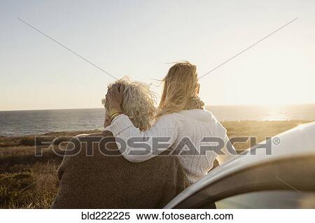Stock Photography - Older Caucasian couple looking at ocean view. Fotosearch
