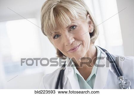 Stock Image - Older Caucasian doctor wearing stethoscope. Fotosearch