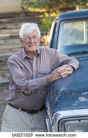 Older Caucasian man standing at truck View Large Photo Image Stock Photo - Older Caucasian man standing at truck. Fotosearch